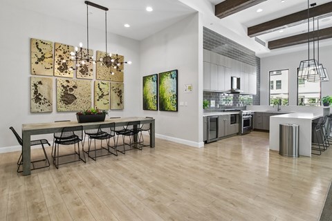 A modern dining room with a long table and chairs.