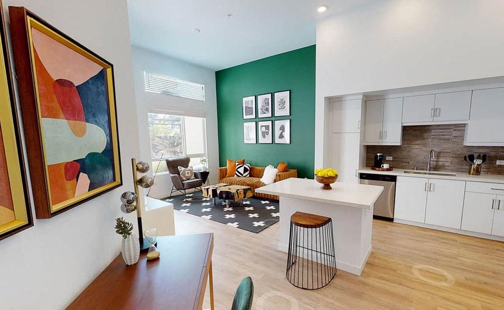 a living room with a couch and a kitchen