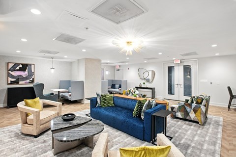 A living room with a blue couch and a coffee table.
