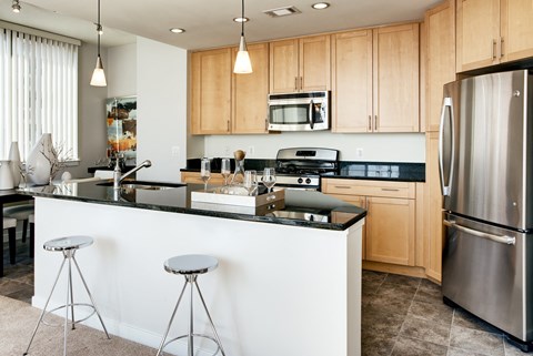A kitchen with a white counter and a refrigerator.