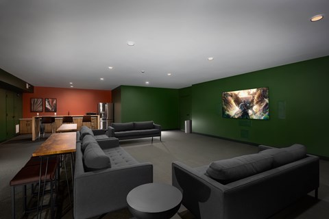 A modern living room with a grey couch and a wooden table.