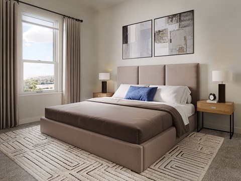 A bedroom with a large bed and a window overlooking a landscape.