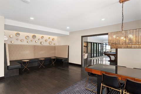 A modern dining room with a glass table and chairs.