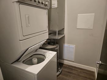 A white oven and washing machine in a small laundry room.