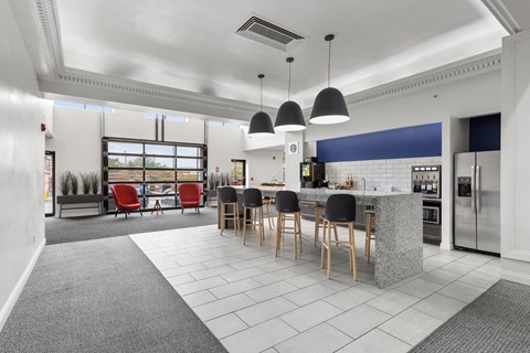 a large room with a kitchen and a table with chairs