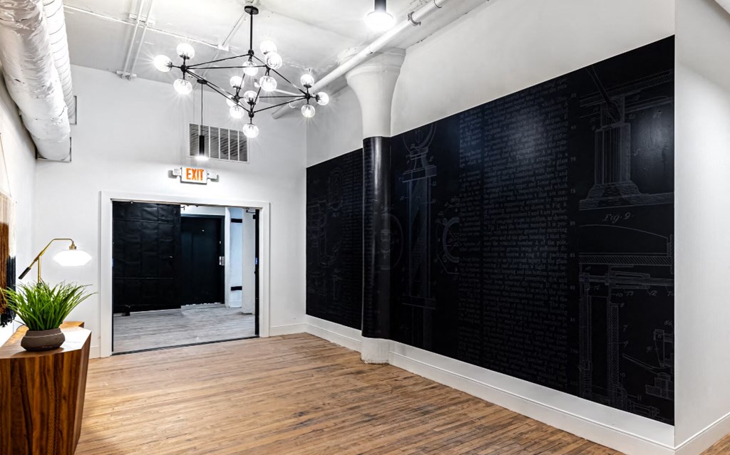 a large room with a black wall and a door