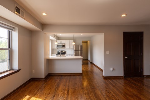 a kitchen and living room in an open floor plan a kitchen and living room in an open floor plan