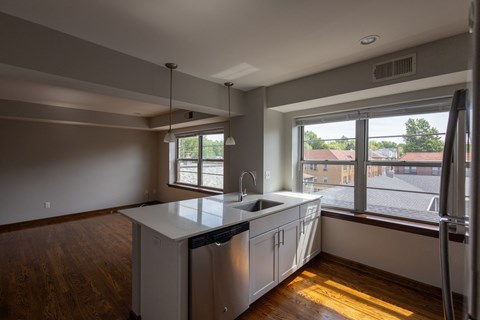 a kitchen with a large window and a sink a kitchen with a large window and a sink