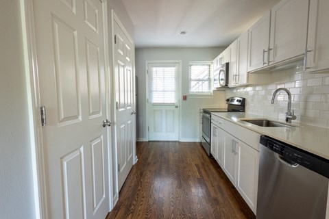 a kitchen with white cabinets and a stainless steel dishwasher a kitchen with white cabinets and a stainless steel dishwasher