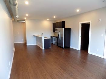 A kitchen area with a refrigerator, microwave, and oven.