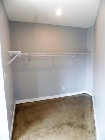 Empty room with a white wall and a white shelf.