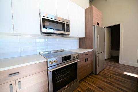 a kitchen with a stove microwave and refrigerator