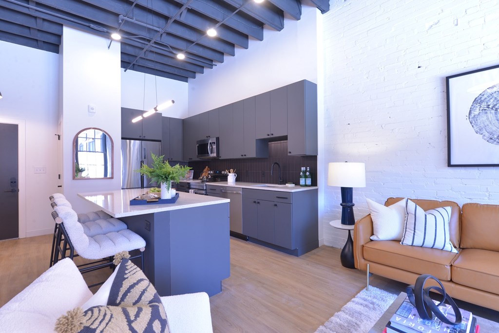 A modern kitchen with a dining table and a couch.