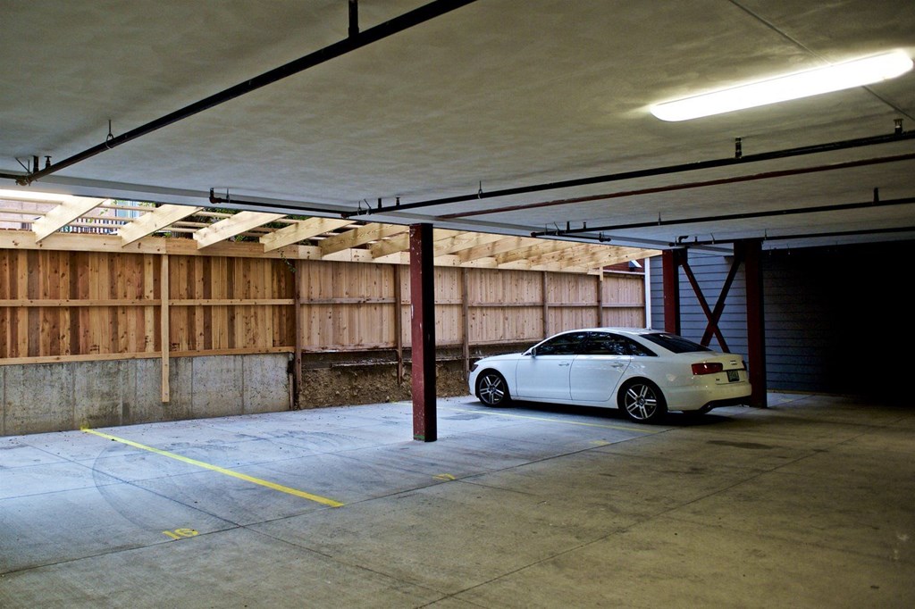 A white car is parked in a garage.