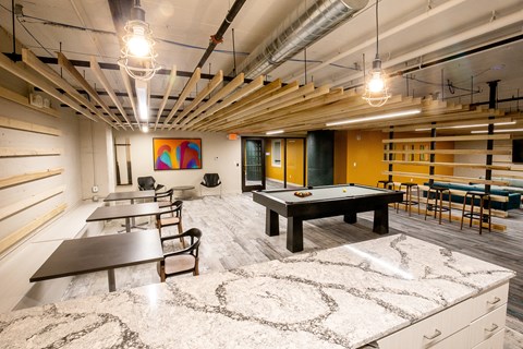 A room with a pool table and a ping pong table.