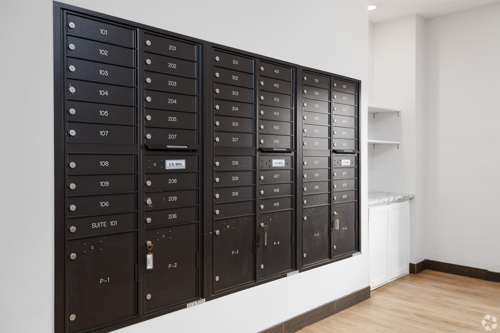 A wall of mailboxes with the numbers 101 to 123 on them.