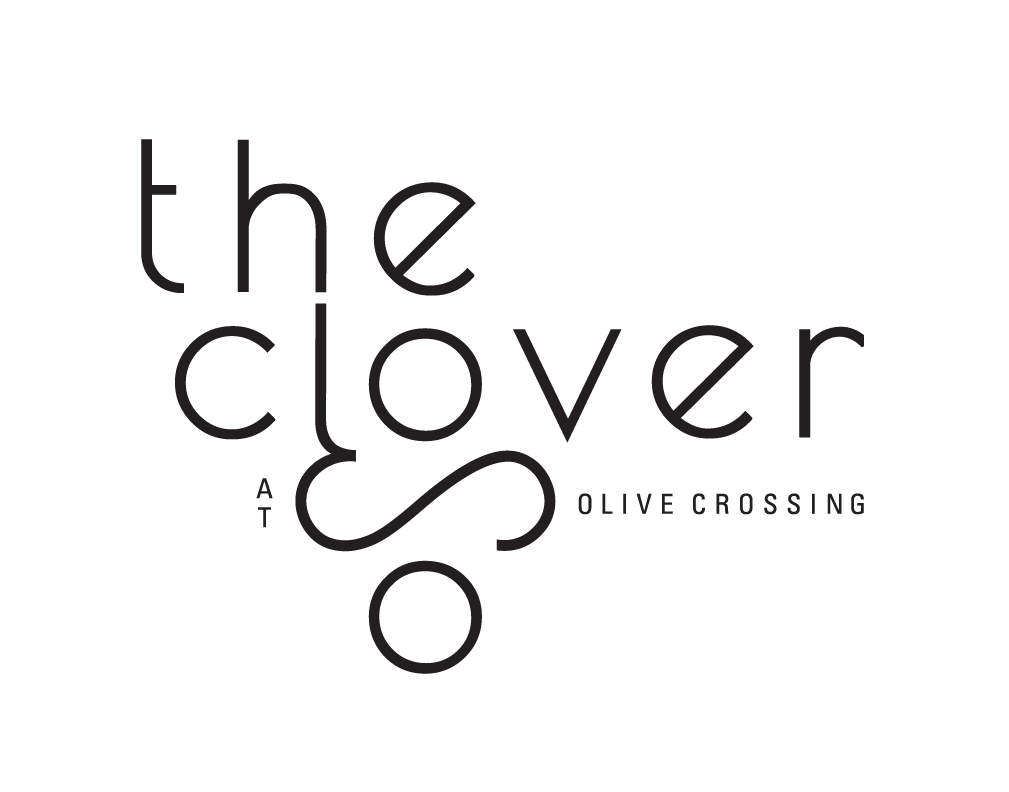The image displays a logo with the text "the clover Olive Crossing" in a stylized font.