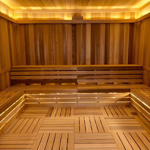A sauna with wooden benches and walls.