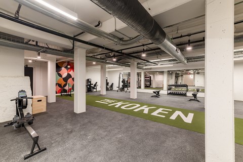 A gym with a green floor mat that says
