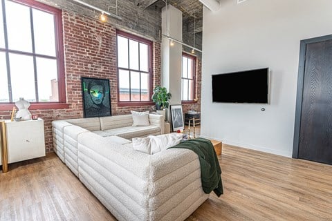 a living room with a couch and a tv in a loft