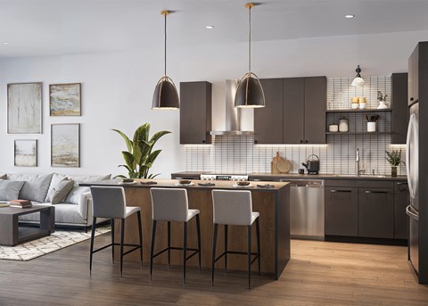 A modern kitchen with a bar area and a dining table.