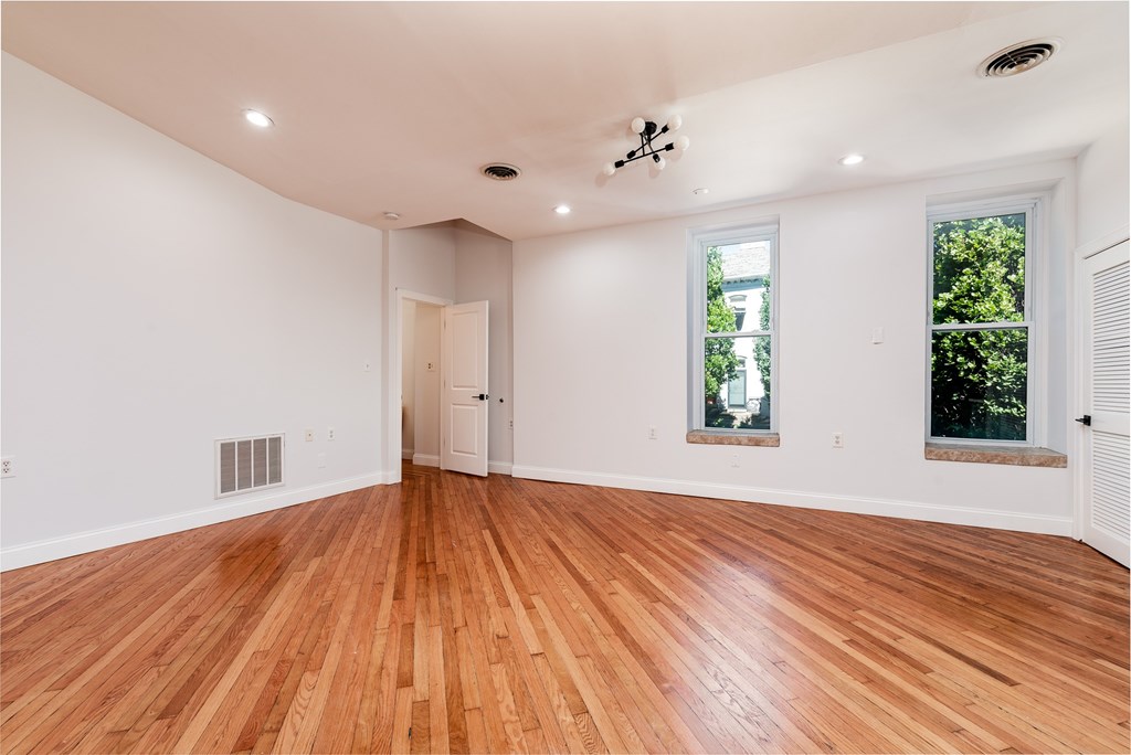 A room with wooden floors and white walls.