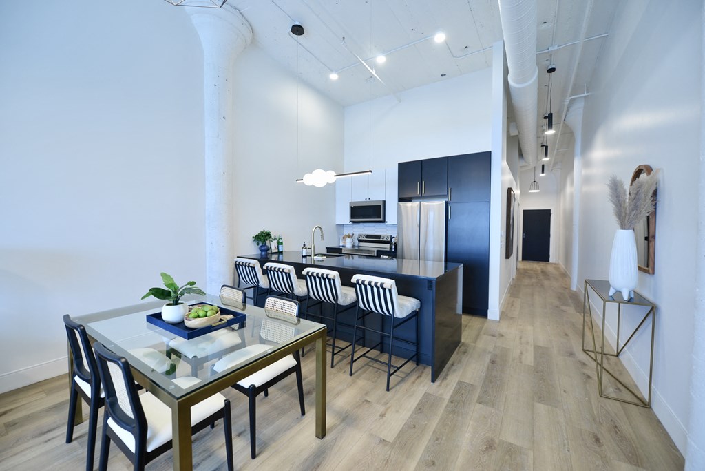 a dining room and kitchen with a table and chairs