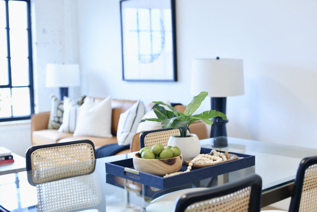 a living room with a table with a bowl of fruit on it