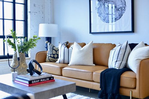 a living room with a brown leather couch and a coffee table