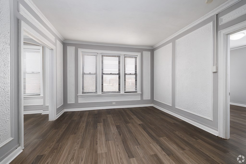 A room with wooden floors and white walls.