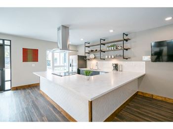 a large white kitchen with a large center island