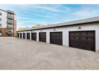 a row of garages in front of an apartment building