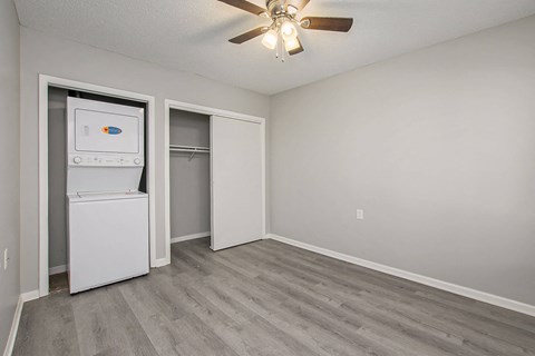 Bedroom with a washer and dryer in the corner