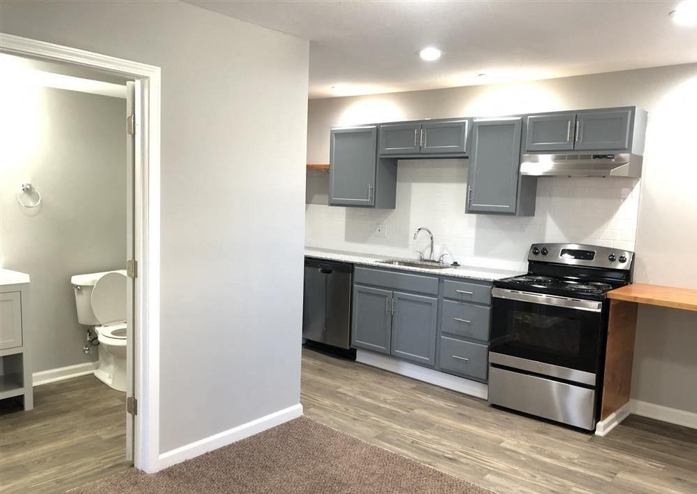 A kitchen with a stove, oven, and cabinets.