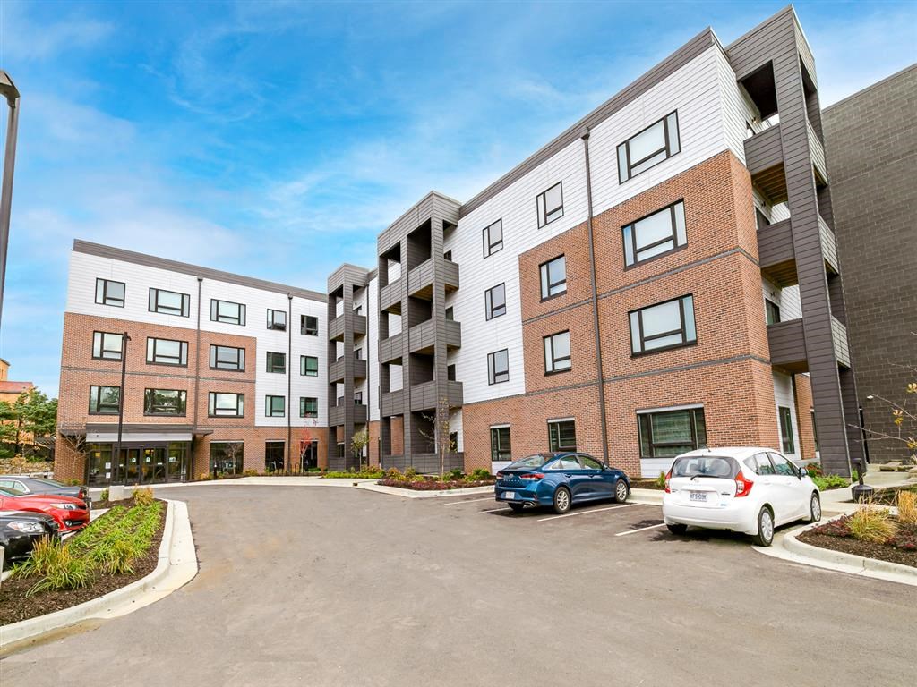 a large brick building with a parking lot in front of it
