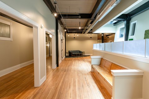 A long hallway with a bench and a table.