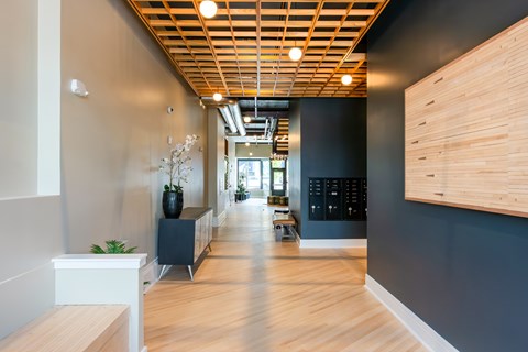 A long hallway with a wooden floor and ceiling.