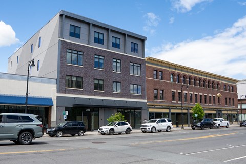 A street view of a city with cars and buildings.