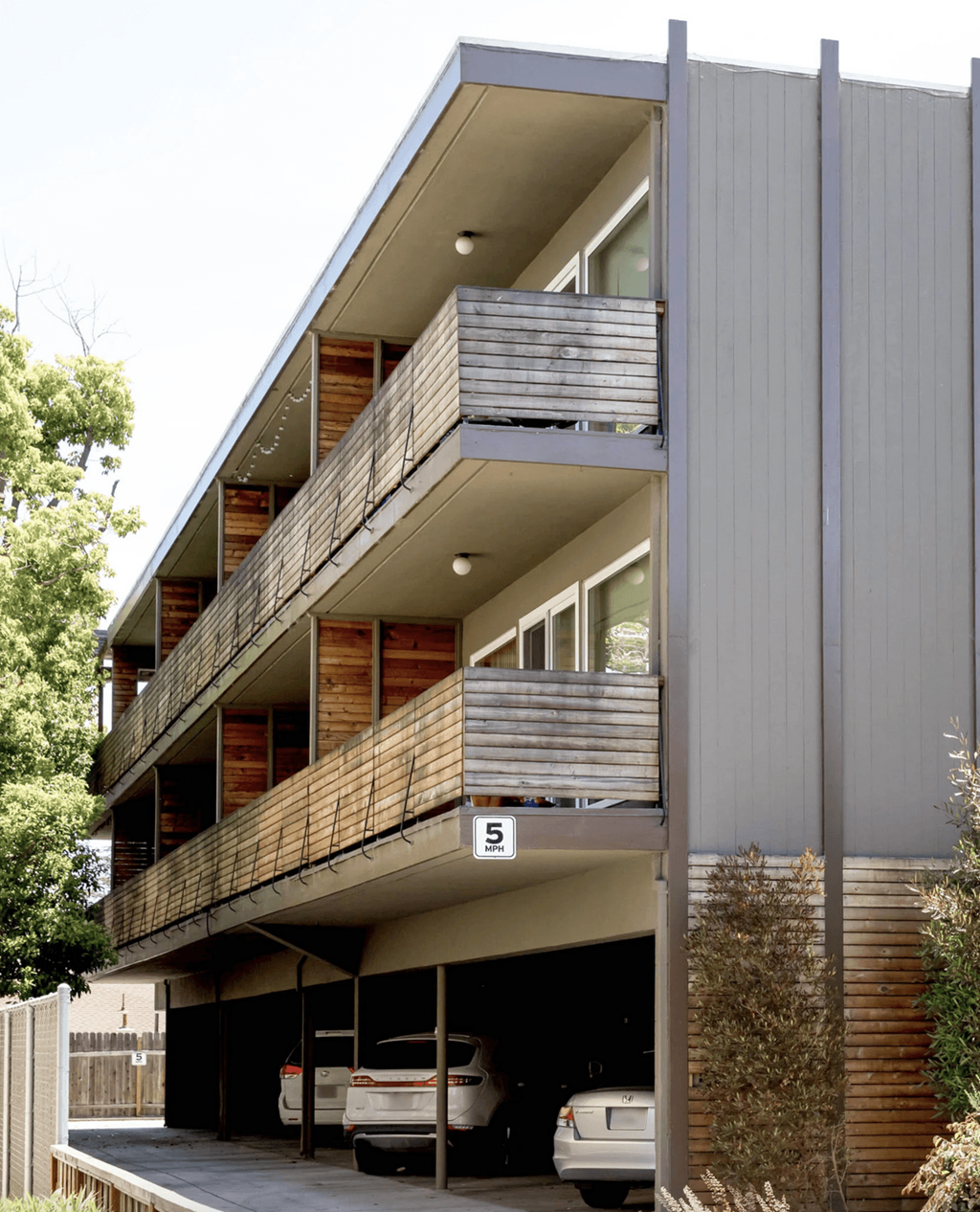 A modern building with a balcony and a garage.