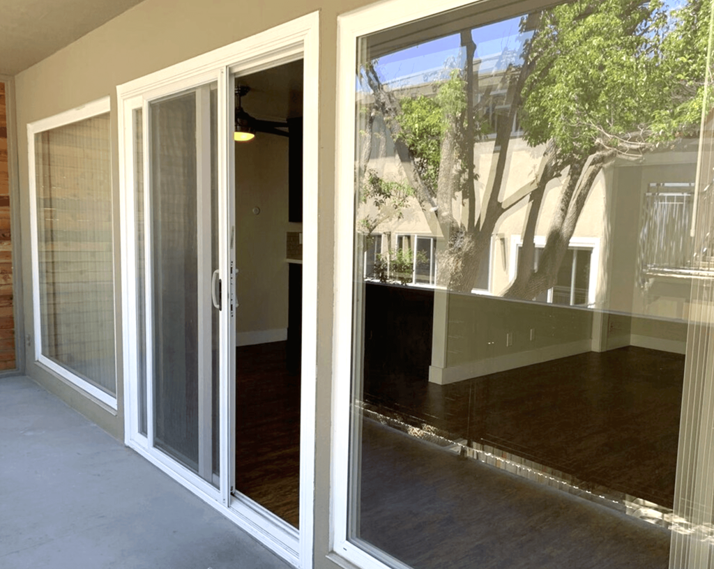 A view of a patio with a sliding glass door.