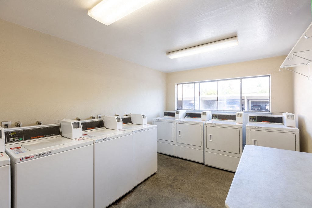 a washer and dryer room with washes and washing machines