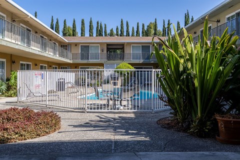 a building with a pool and a fence in front of it