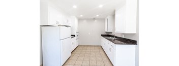 a white kitchen with white appliances and white cabinets