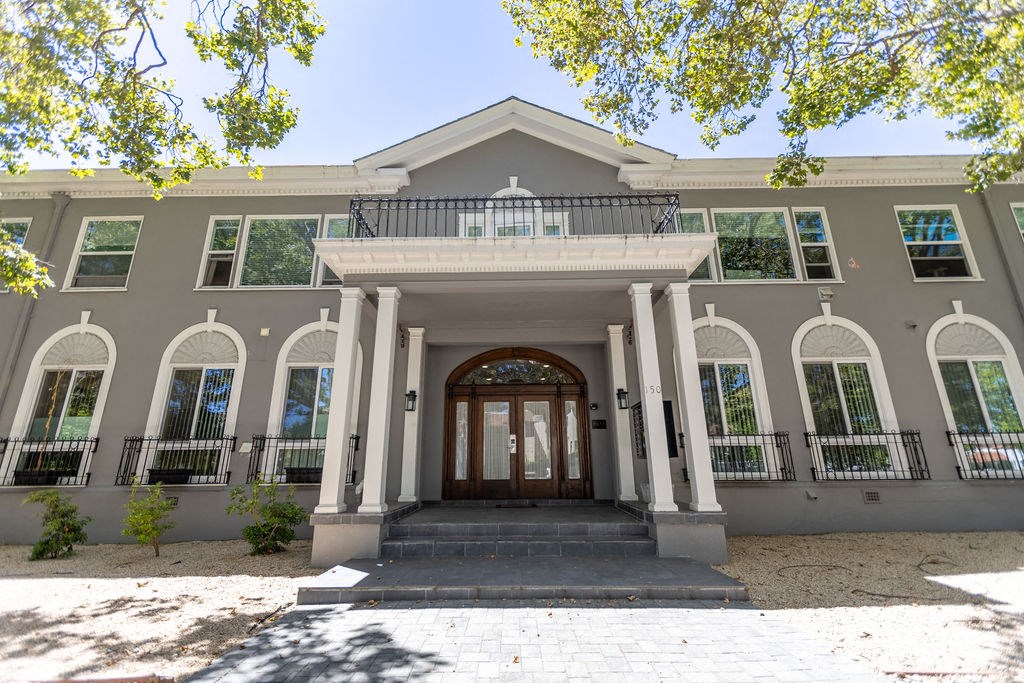 the front of a building with columns and a door