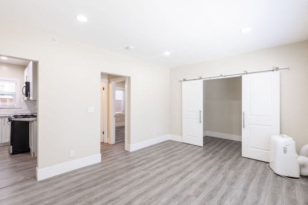 a living room with a door to a closet