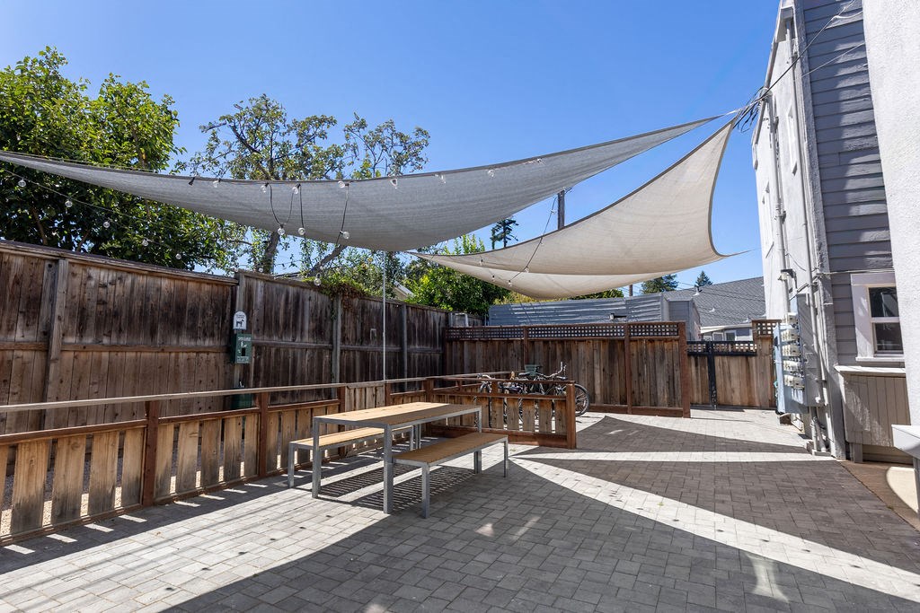 a patio with a picnic table and a hammock