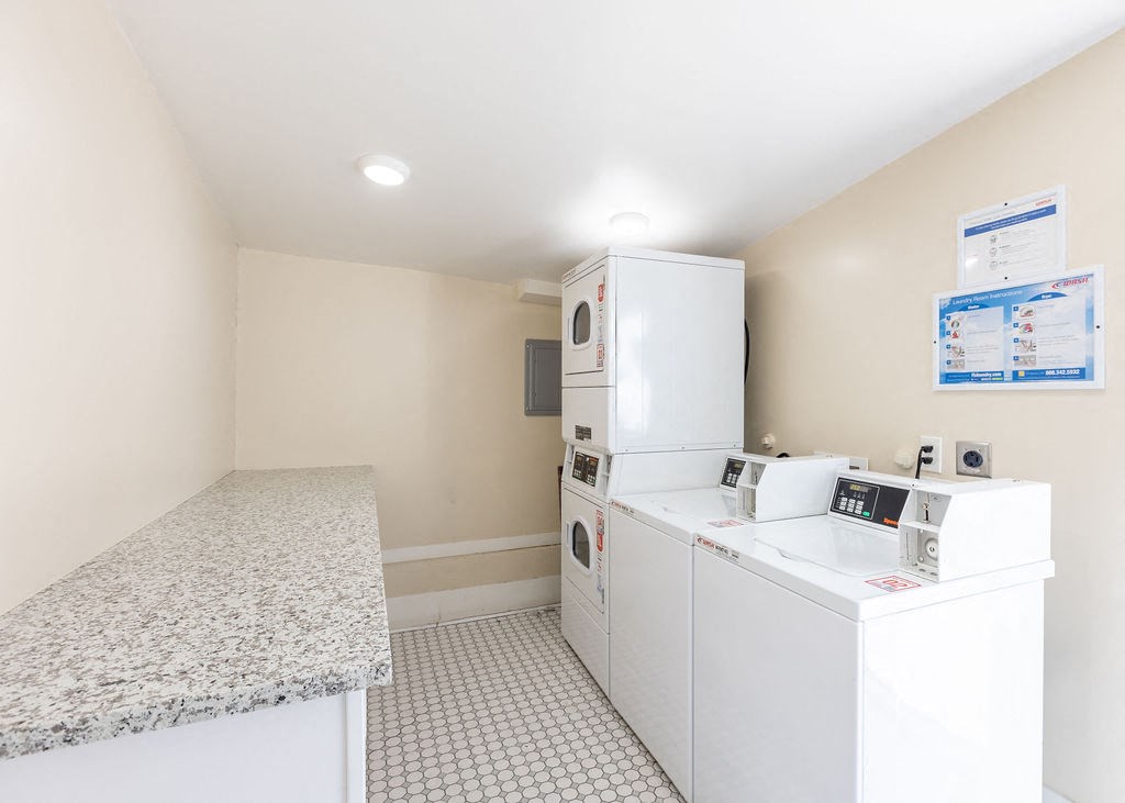a laundry room with washer and dryer and a counter