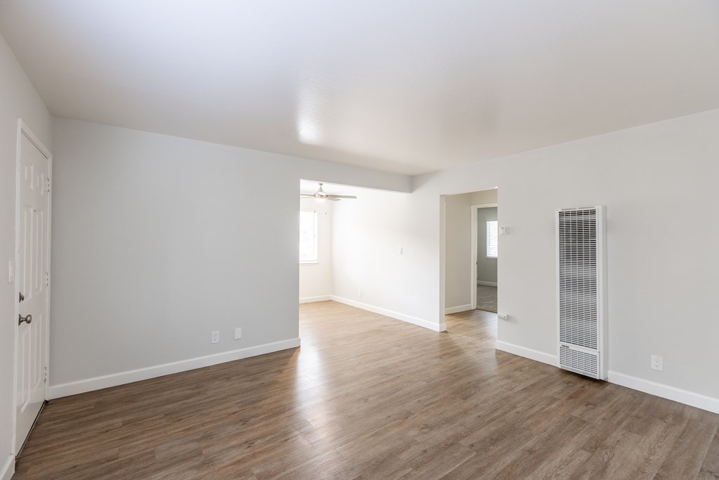 A room with wooden floors and white walls.