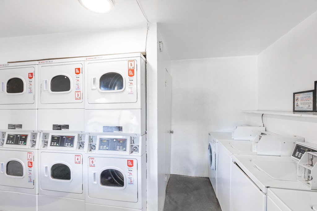 A row of washing machines in a laundromat.