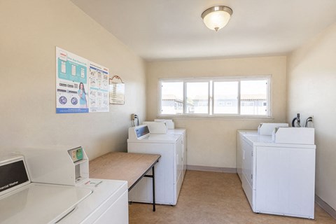 A medical room with a sink, a table, and a poster on the wall.